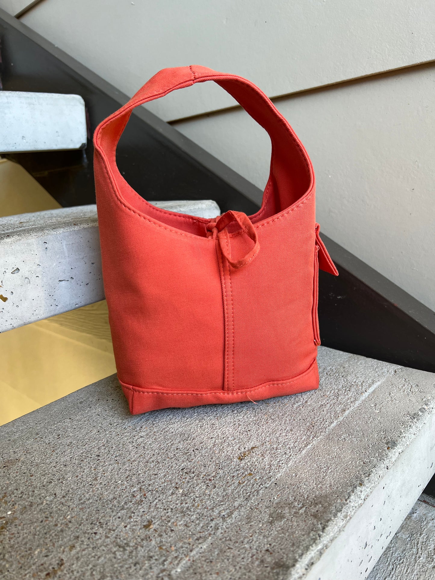 Orange one handle bag