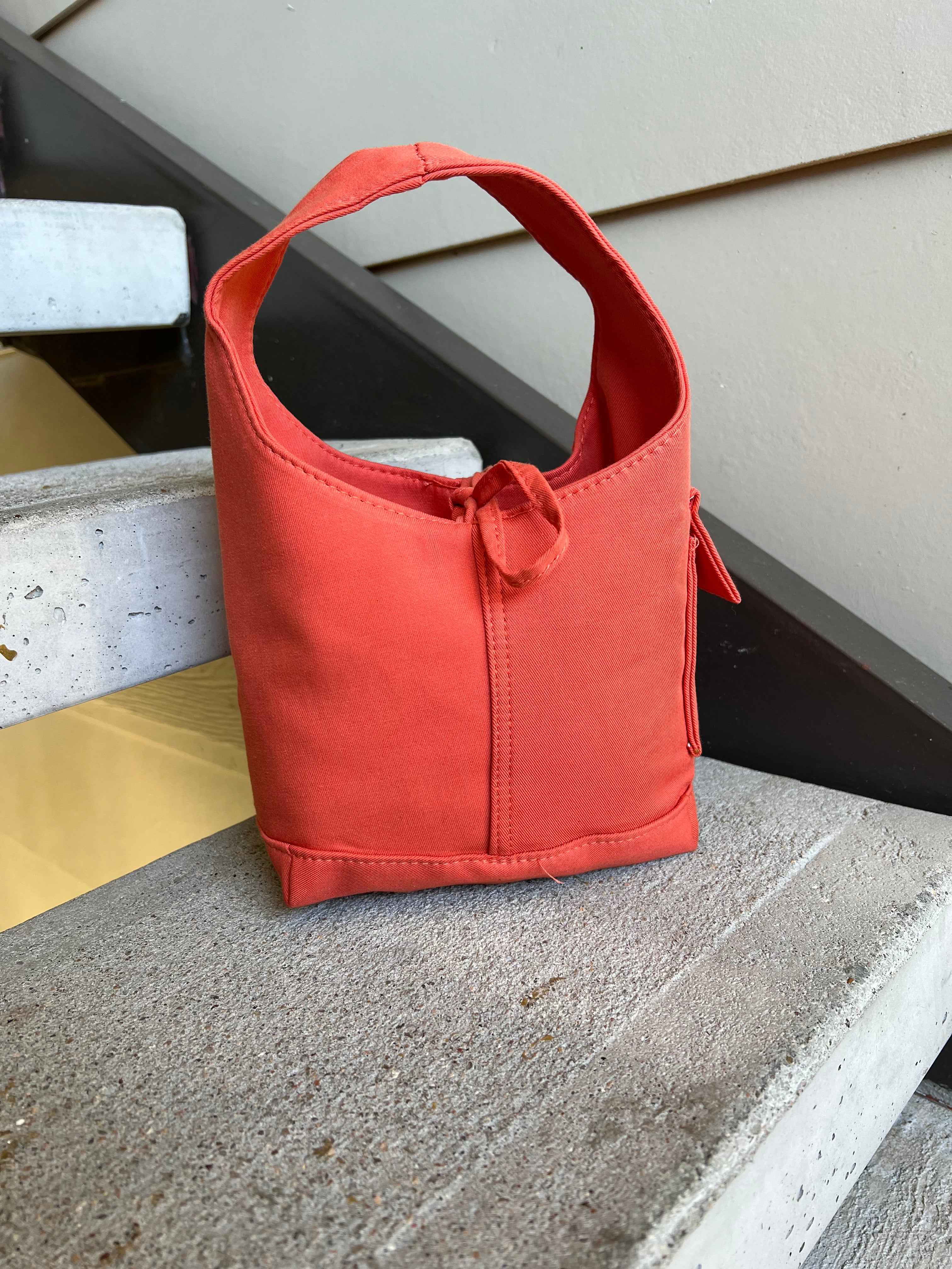 Orange one handle bag