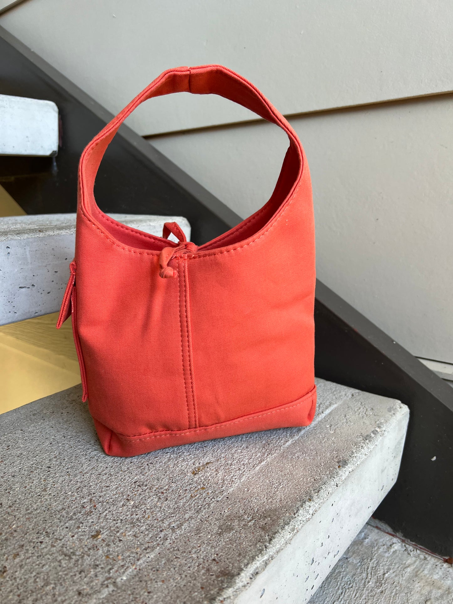 Orange one handle bag